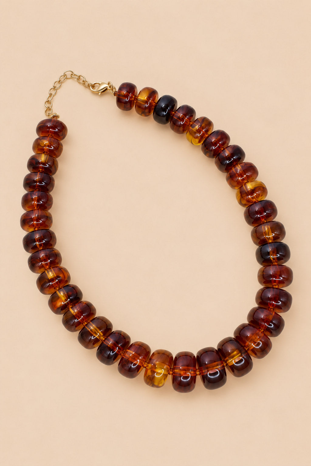 Brown translucent beaded necklace alternate view on beige background
