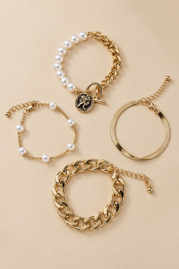 Gold-tone pearl bracelet set arranged naturally on a warm beige background.
