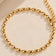 Close-up alternate view of gold-tone oval beads, clasp and extender chain.