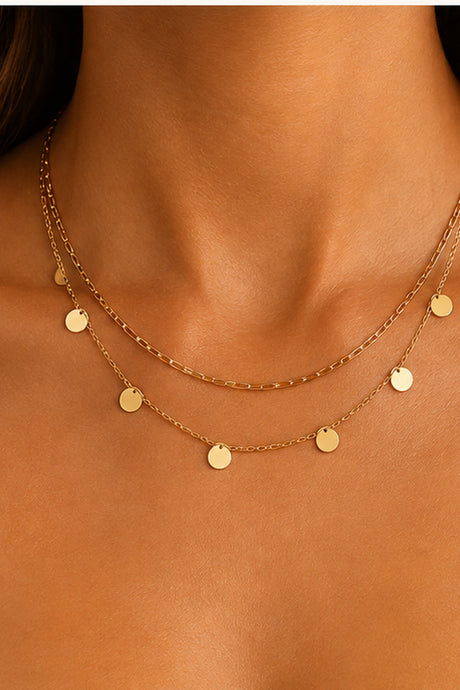 Gold-Tone Double-Layer Disc Necklace close-up on bare neckline, solid upper chain and lower disc charm chain