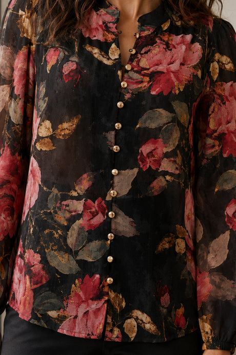 Makenzie blouse close-up showing textured floral fabric and gold buttons