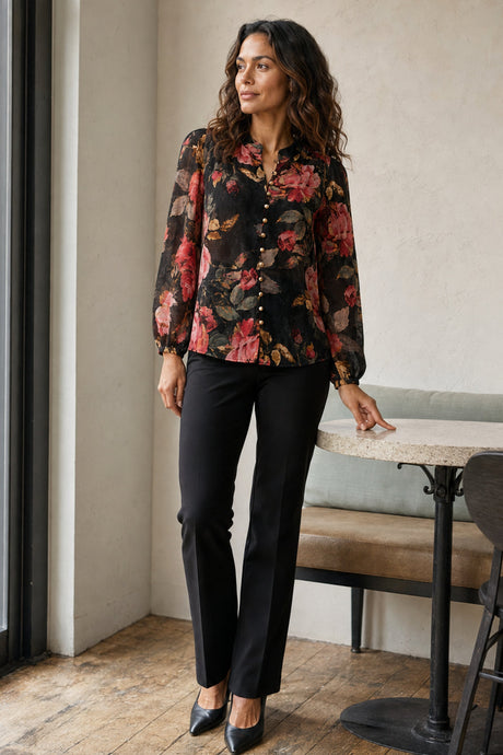 Makenzie black floral gold-button blouse on Yasmine in a café