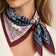 Model wearing a patchwork paisley square scarf in navy, ivory and burgundy