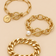 Gold-tone pearl coin bracelet set on beige background