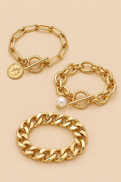 Gold-tone pearl coin bracelet set on beige background
