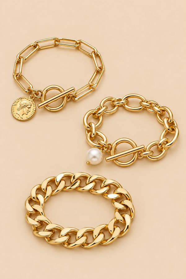 Gold-tone pearl coin bracelet set on beige background