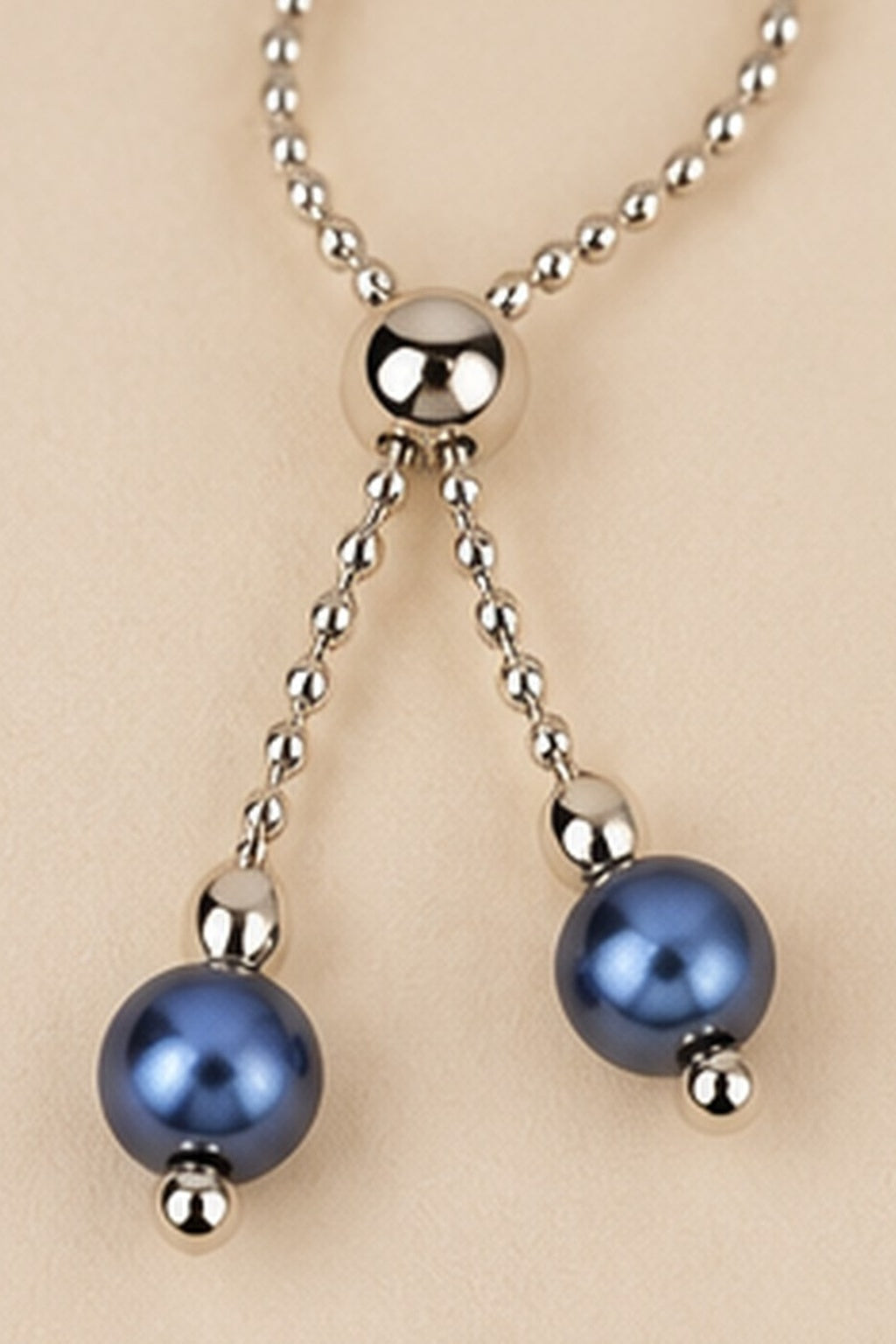 Detail of the adjustable slider and dangling blue beads on the Pearl Slider Bracelet.