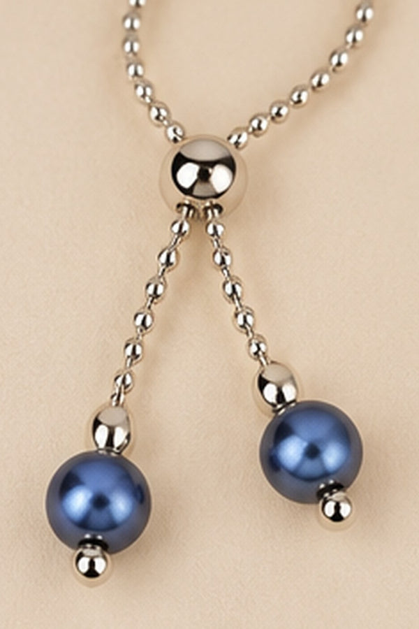 Detail of the adjustable slider and dangling blue beads on the Pearl Slider Bracelet.