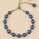 Blue pearl slider bracelet on ONZE beige background.