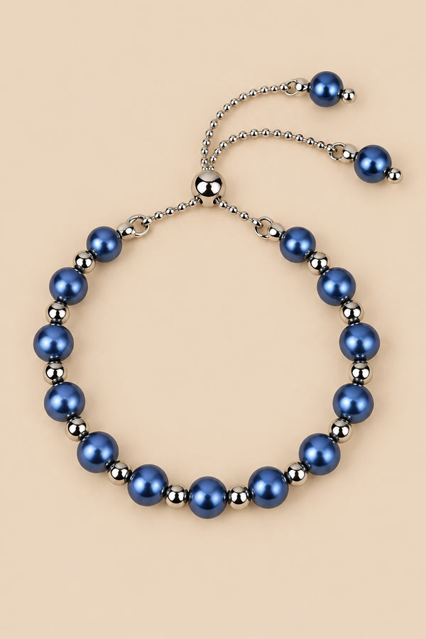 Blue pearl slider bracelet on ONZE beige background.