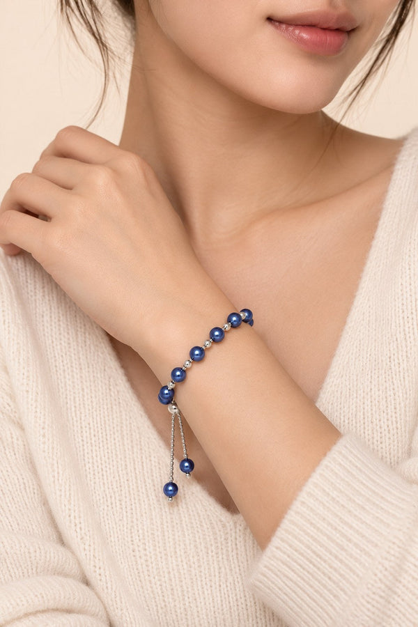 Blue imitation-pearl slider bracelet worn individually on the wrist.