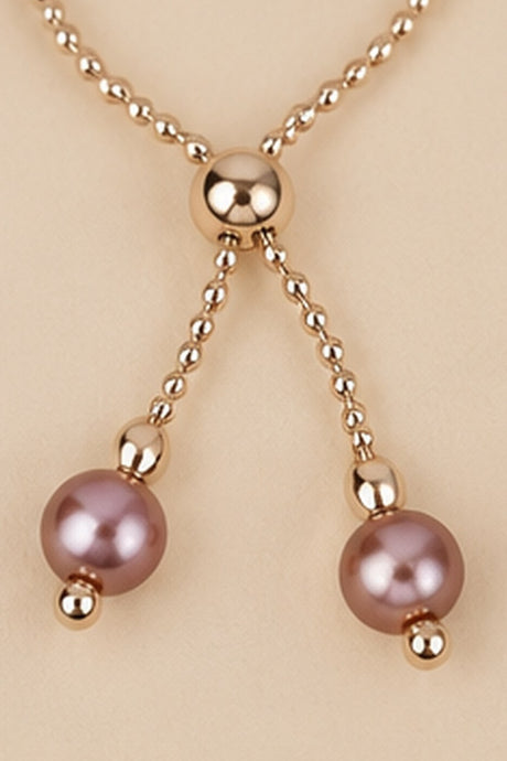 Detail of the adjustable slider and dangling mauve pink beads on the Pearl Slider Bracelet.