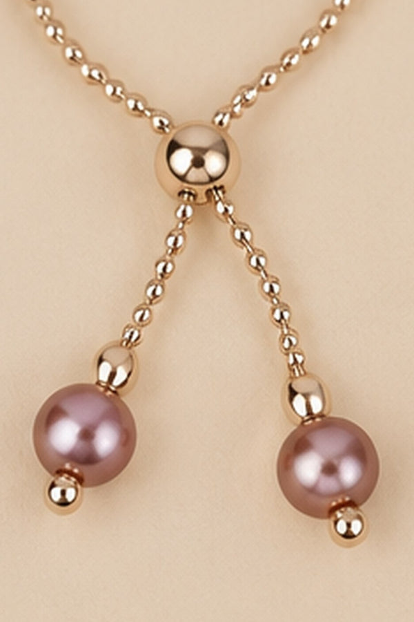 Detail of the adjustable slider and dangling mauve pink beads on the Pearl Slider Bracelet.