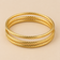 Style 002 three-ring gold-tone bangle set detail view