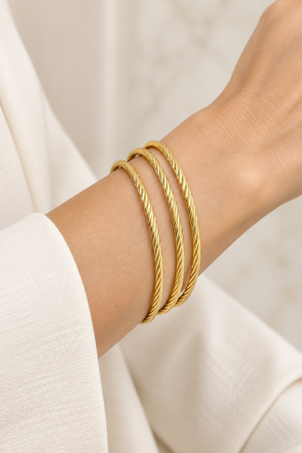 Style 002 three-ring gold-tone bangle set worn on wrist