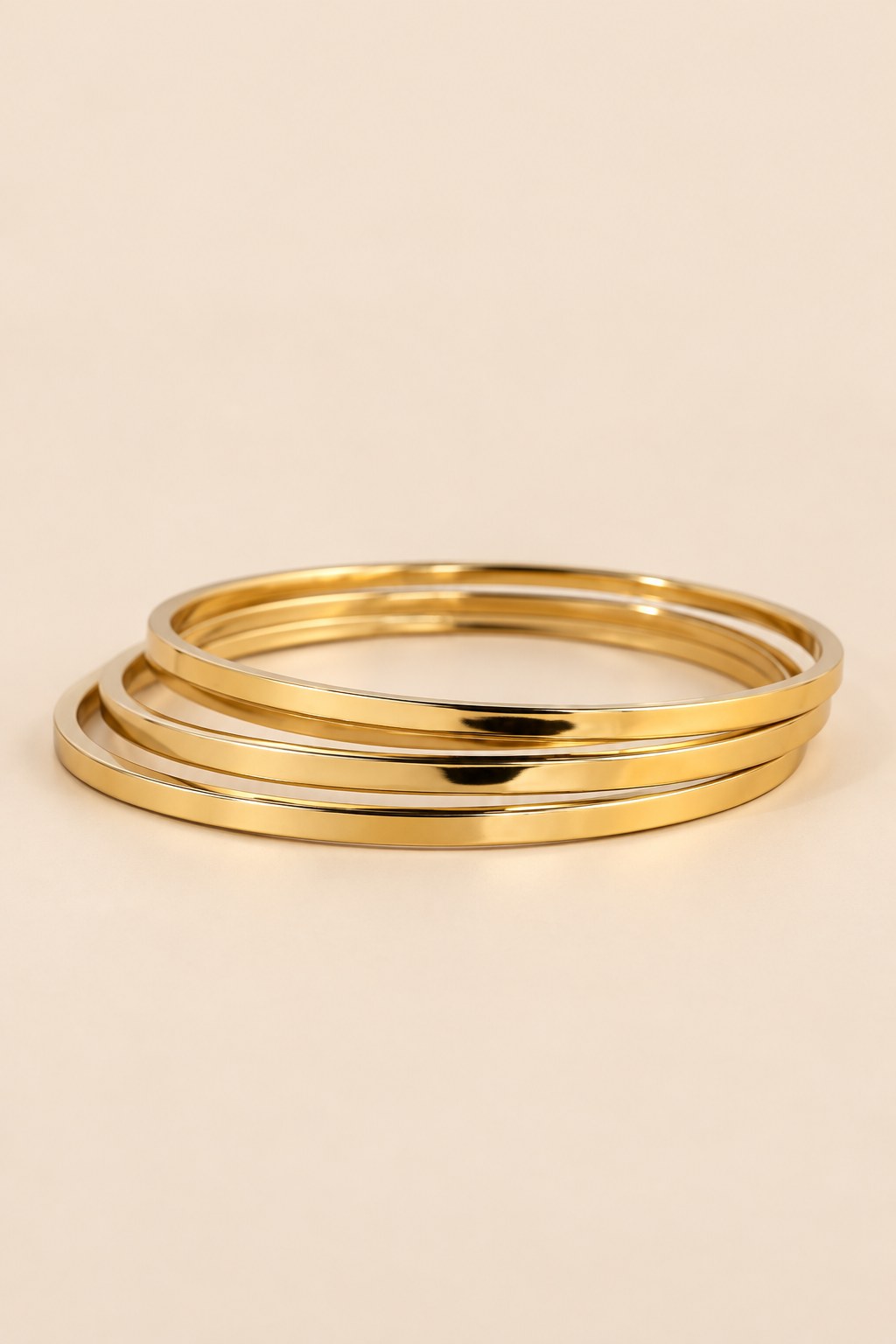 Gold-tone three-ring bangle set shown from an alternate angle.